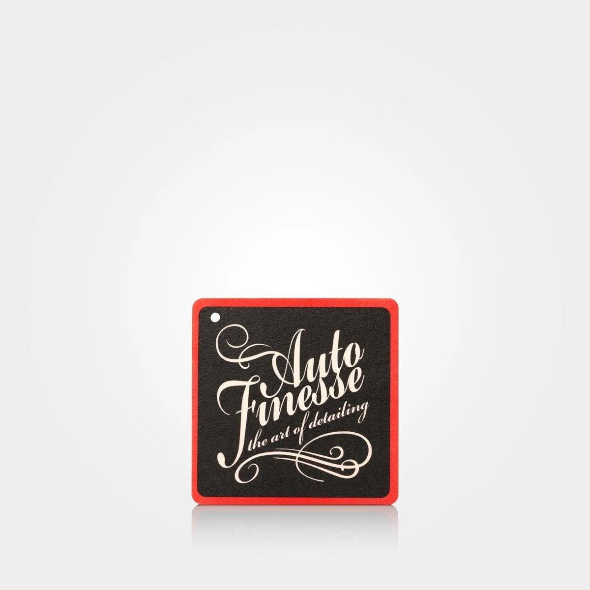 classic red car air freshener by auto finesse hanging inside car interior long lasting fragrance