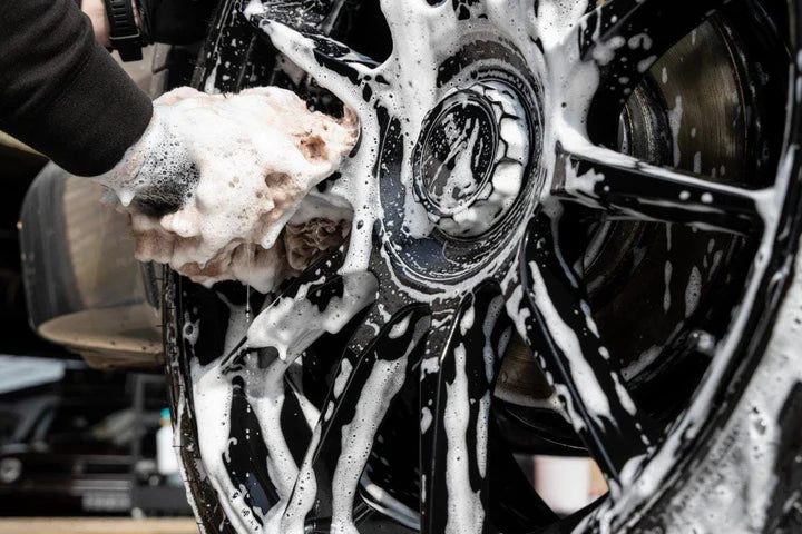 car wheel being cleaned with auto finesse revolution wheel cleaner.