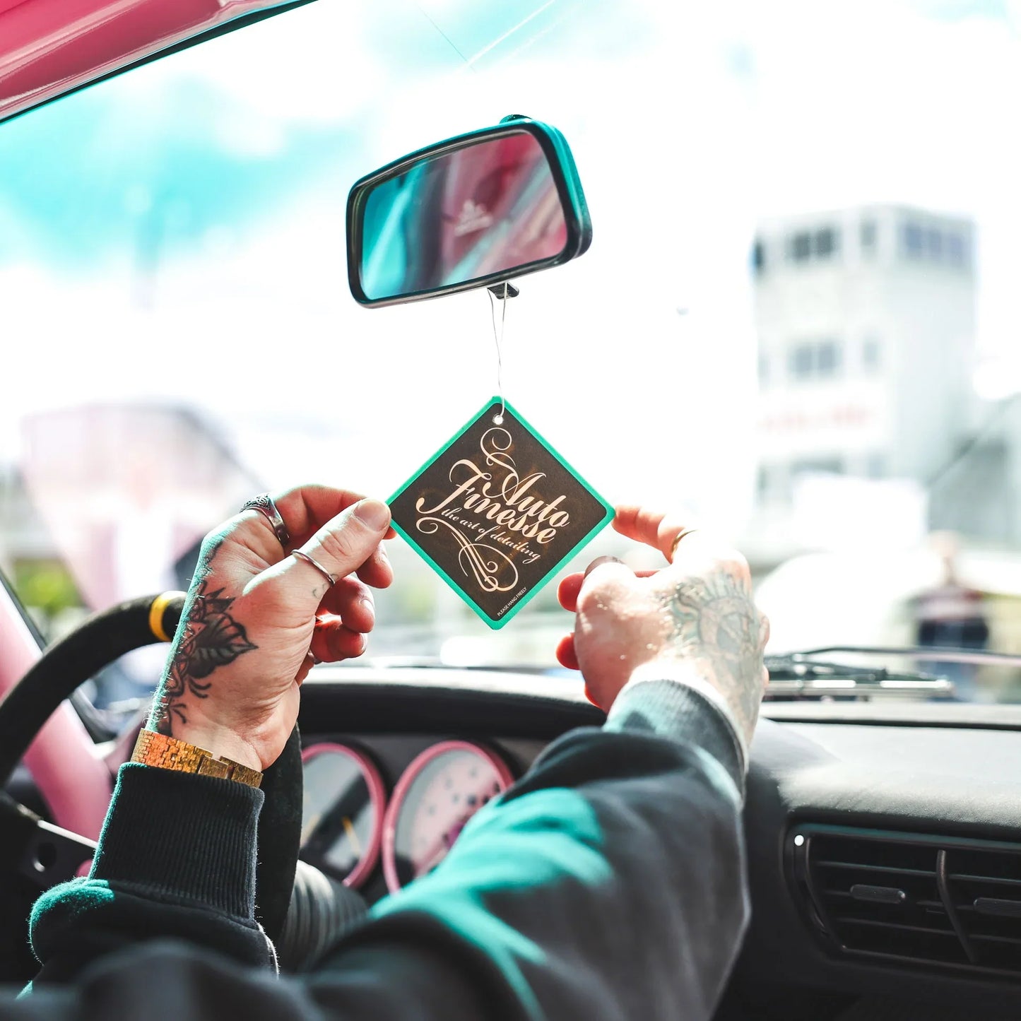 coconut car air freshener by auto finesse hanging inside car interior long lasting fragrance